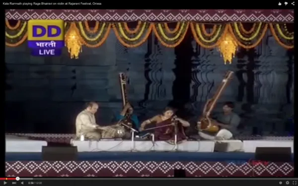 Kalash Ramnath playing Raga Bhairavi on violin at Rajarani Festival, Orissa, India, with traditional stage decorations.