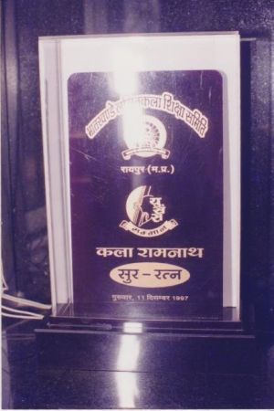 Book with Hindi text cover on a wooden surface.